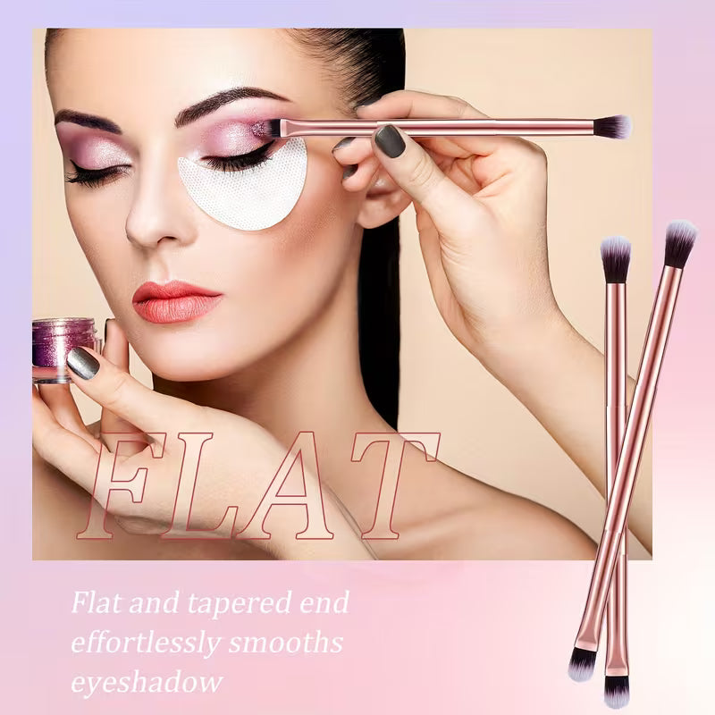 Woman applying makeup with a brush, surrounded by makeup brushes on a pink background.
