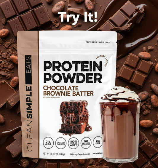 Protein powder package with a glass of chocolate brownie batter shake on a white background
