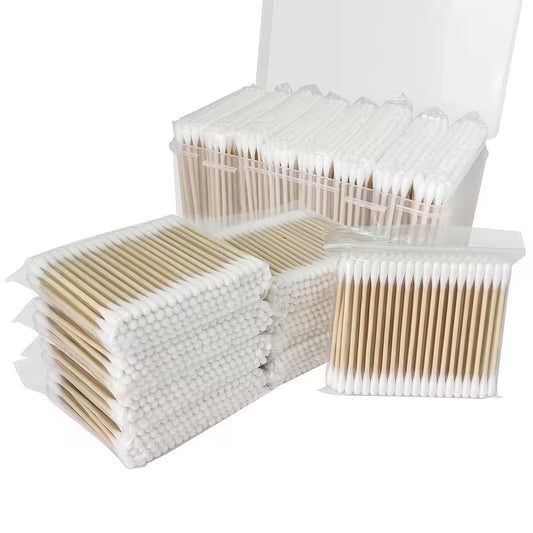 Multiple packages of cotton swabs on a white background