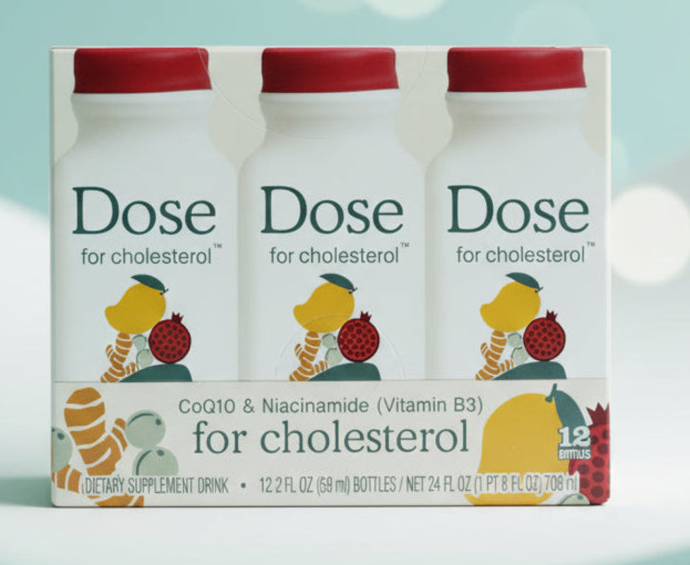 Packaging of 'Dose for cholesterol' dietary supplement drink on a marble background with a thank you message.